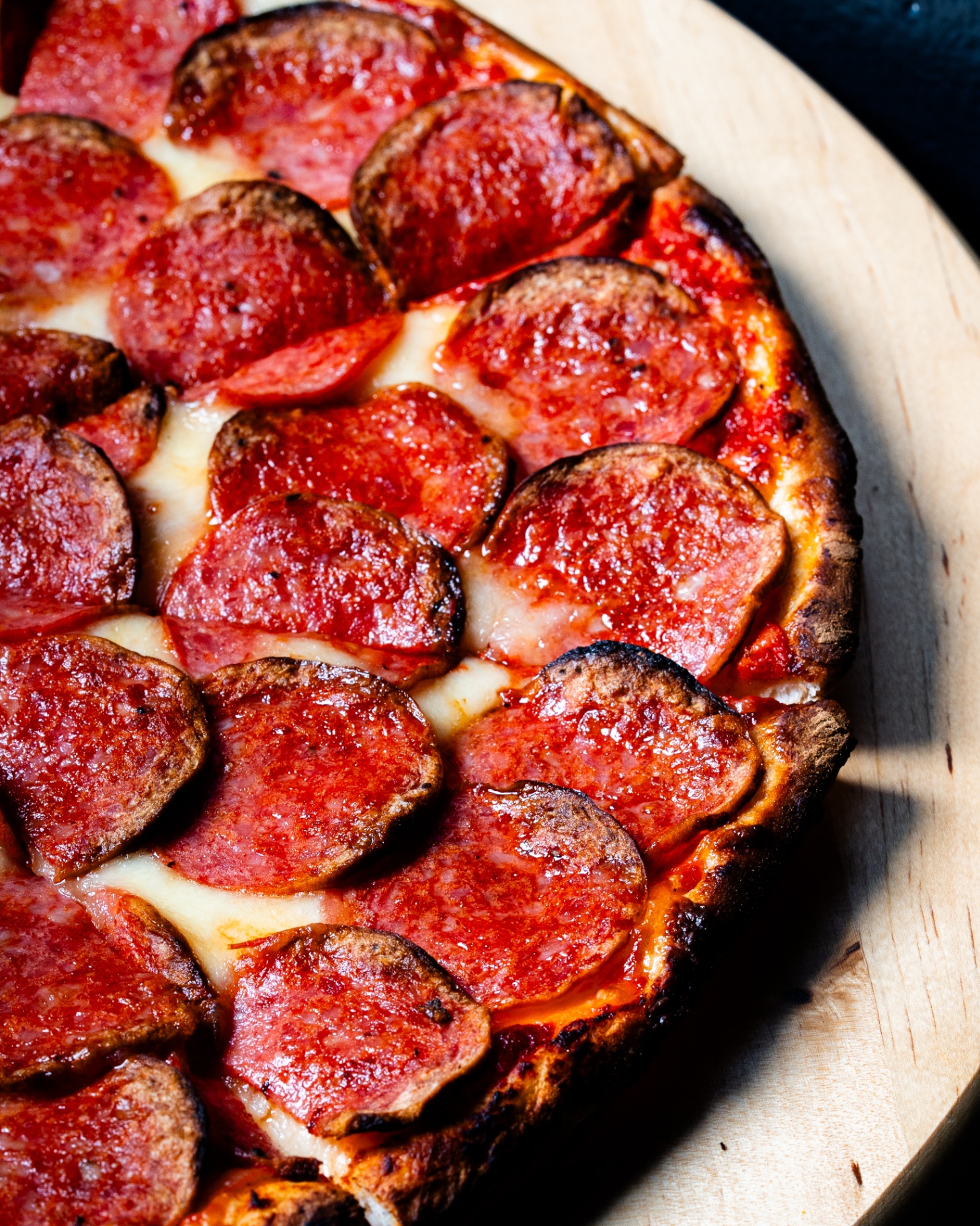 Macro close-up of crispy pepperoni and melted cheese