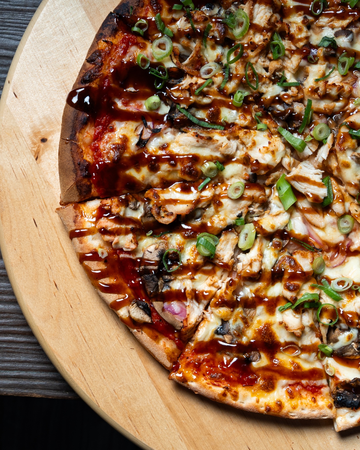 BBQ chicken pizza with spring onion and mushrooms, close-up