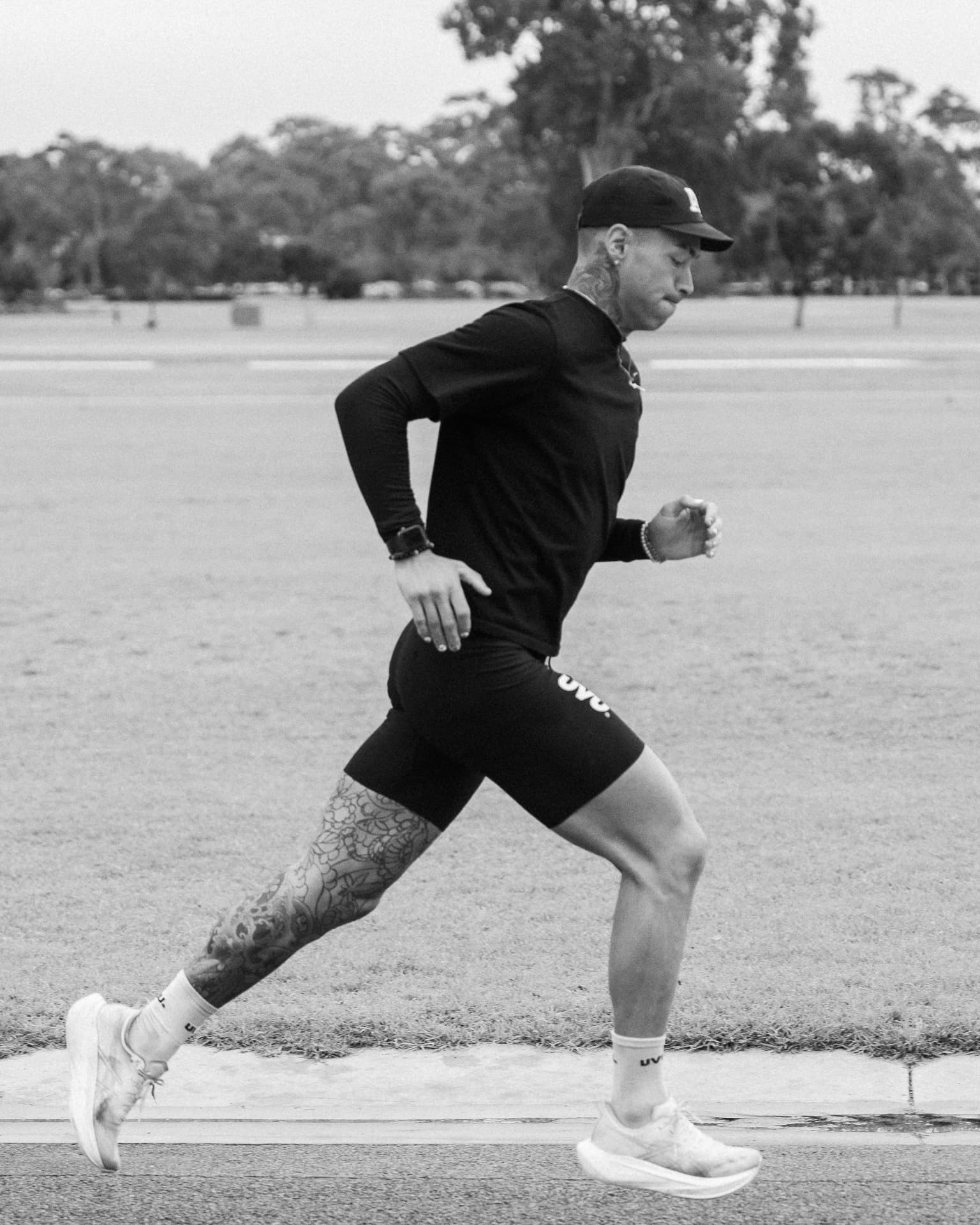 Runner mid-stride along a park road