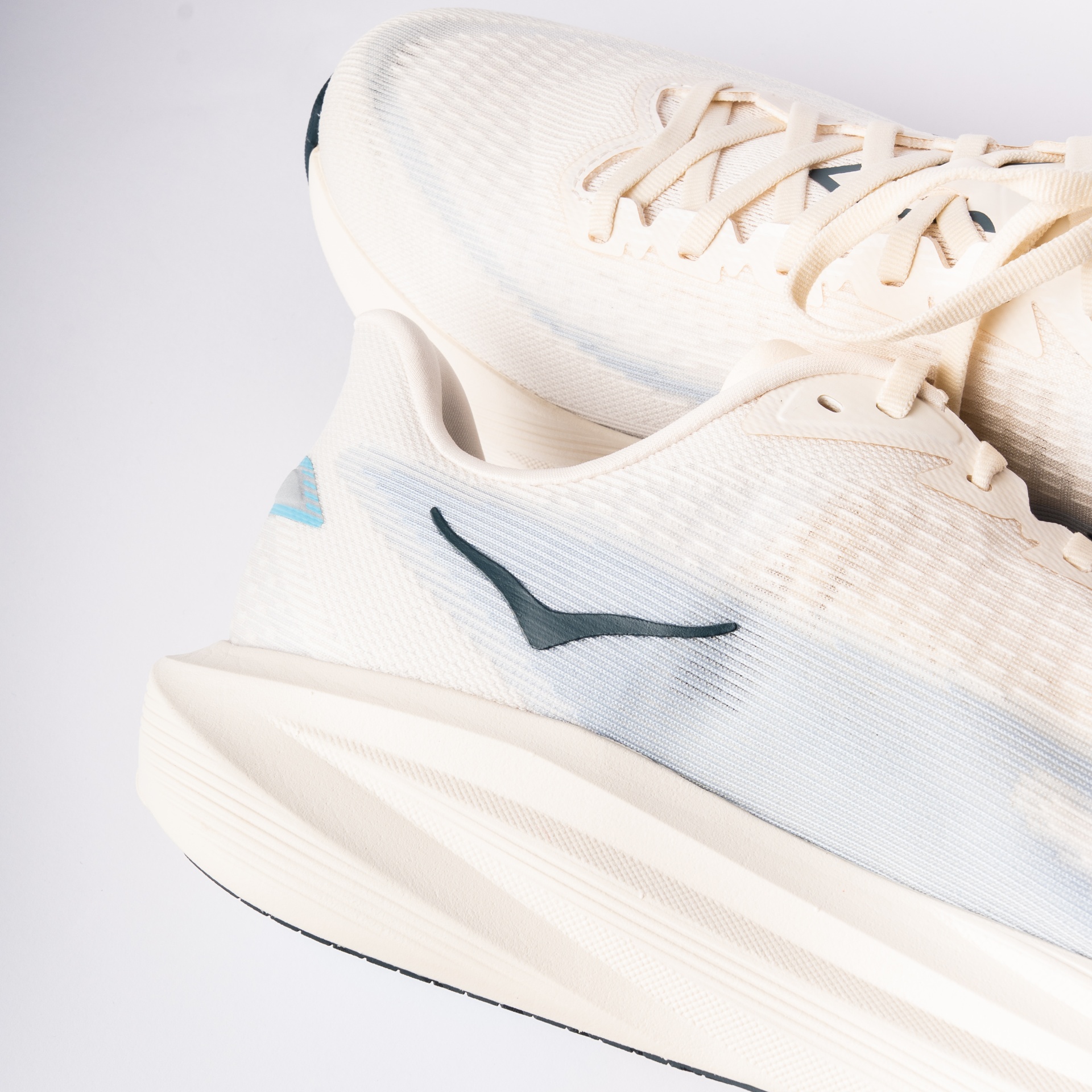 Heel detail of HOKA Mach 7 with navy logo and cream midsole