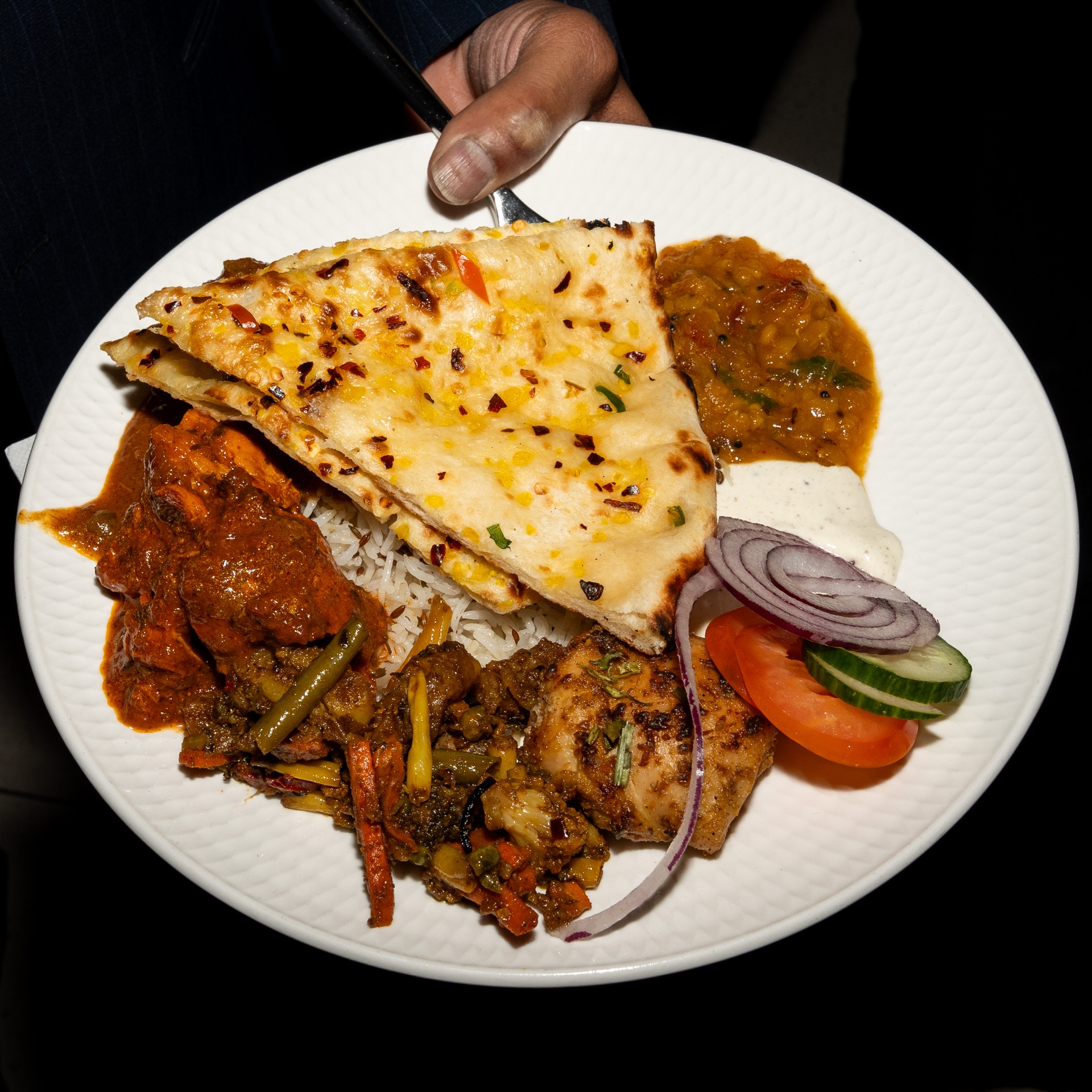 Indian feast plate with naan, curry and rice