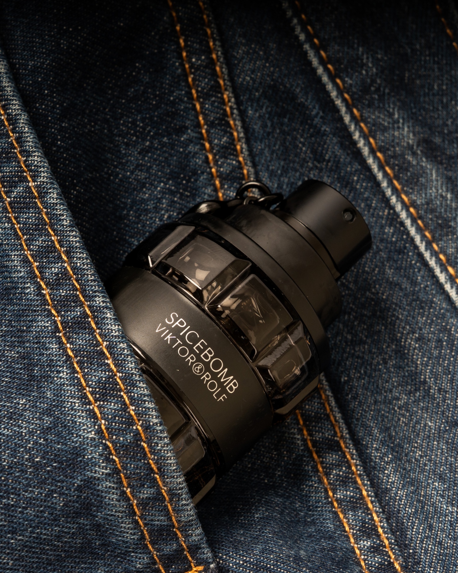 Spicebomb fragrance resting on indigo denim with contrast stitching