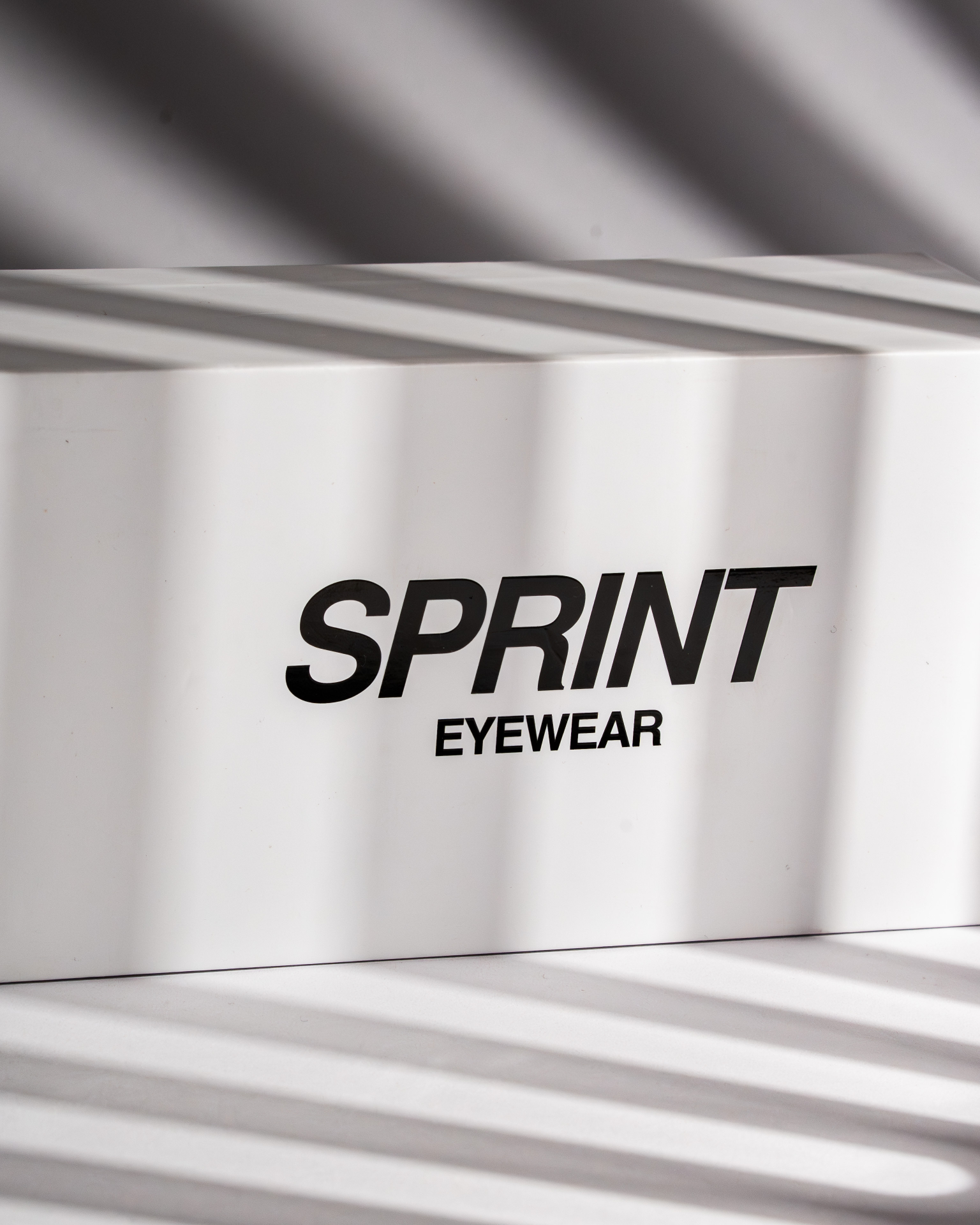 Sprint Eyewear box lit by slatted window light