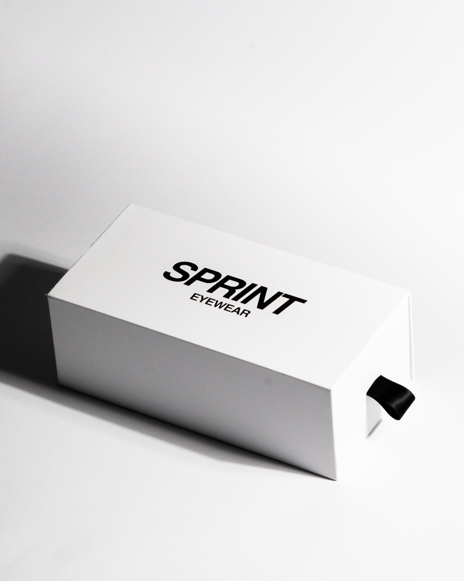Sprint Eyewear white box with black ribbon pull