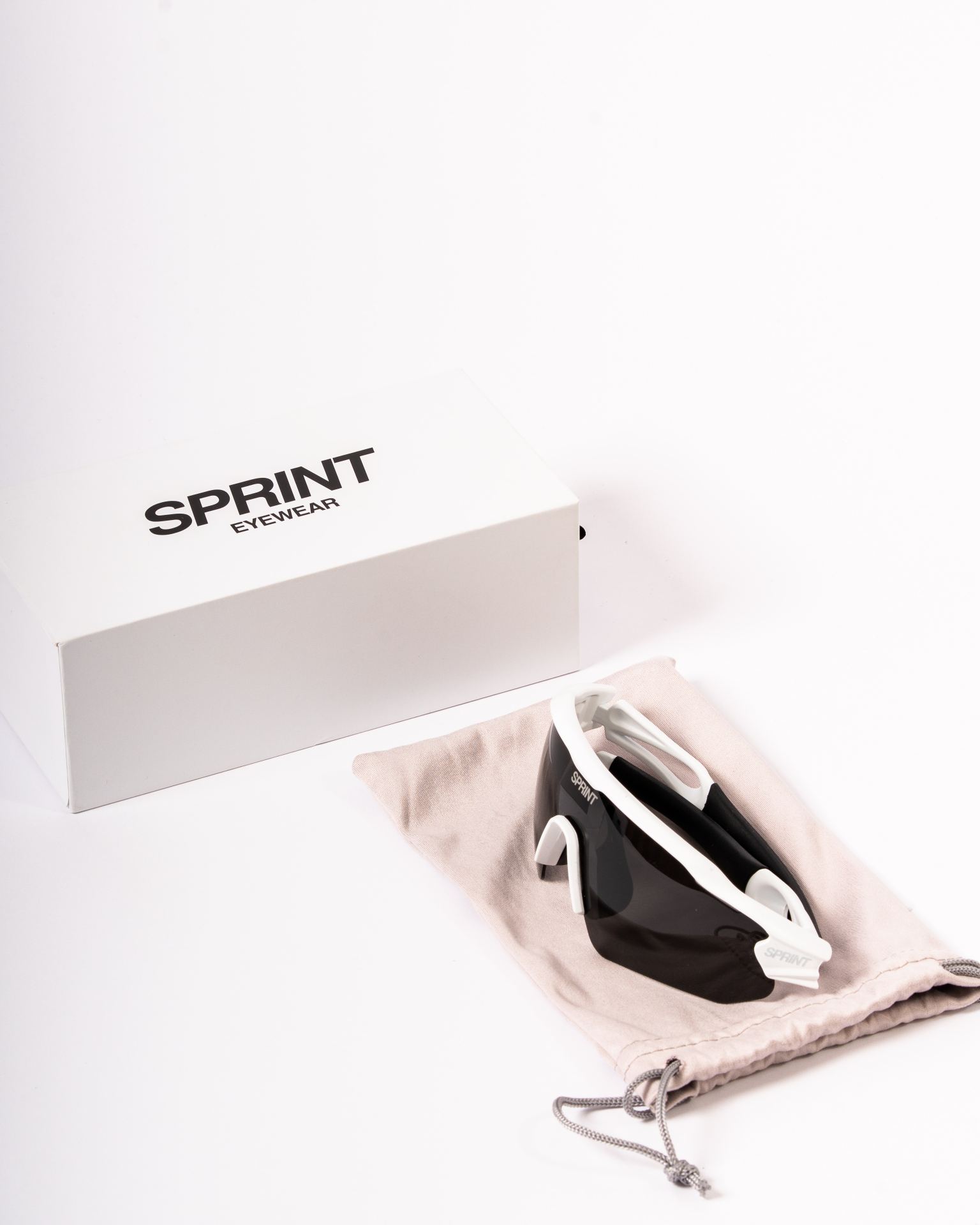 Sprint Eyewear sunglasses on canvas pouch beside white box
