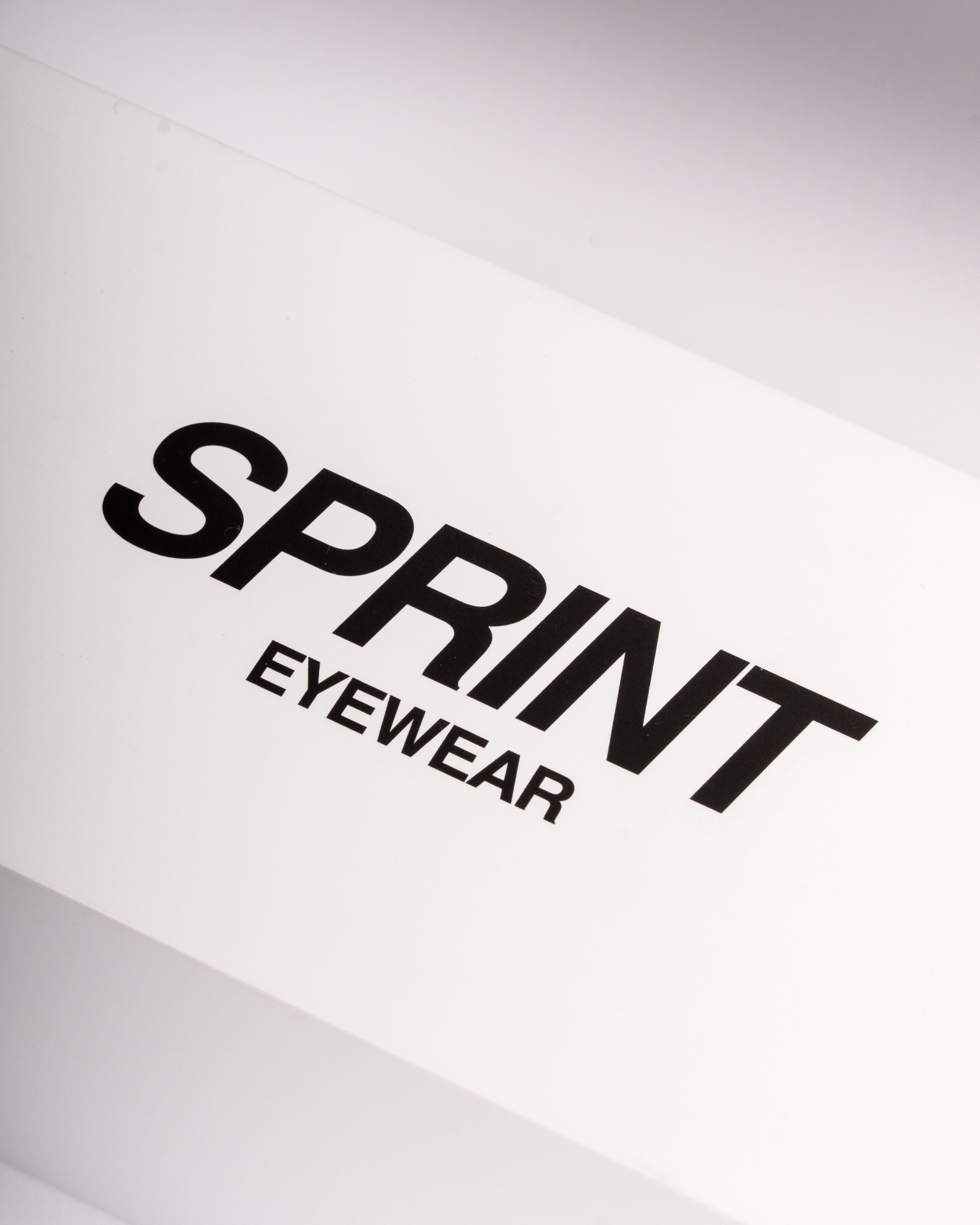Close-up of Sprint Eyewear logo on white packaging